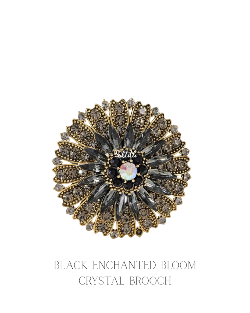 Layered crystal flower brooch on a gold-finish base. One statement piece for a hijab or abaya, in black, purple or yellow.